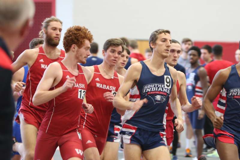 a group of men running in a gym