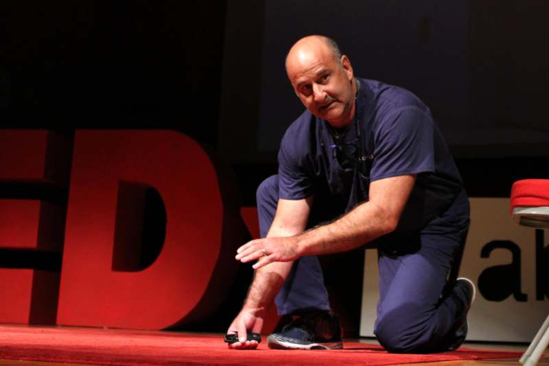 a man kneeling on a stage