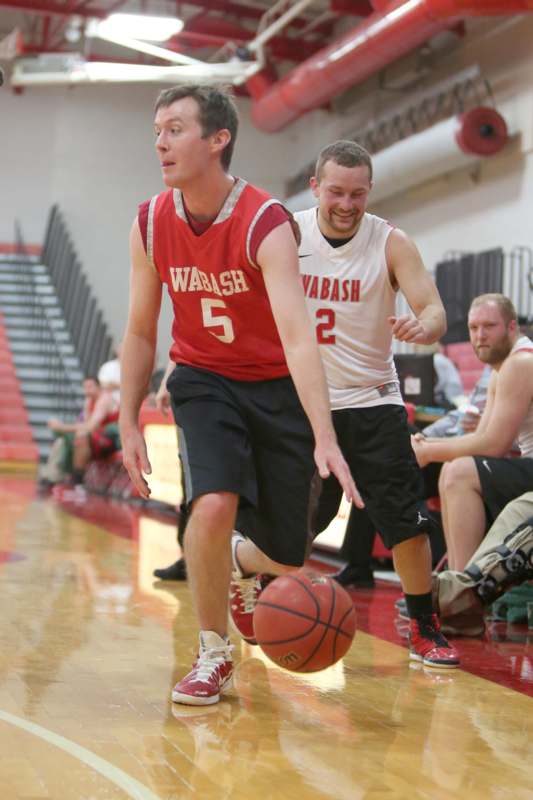a man in a red jersey dribbling a basketball