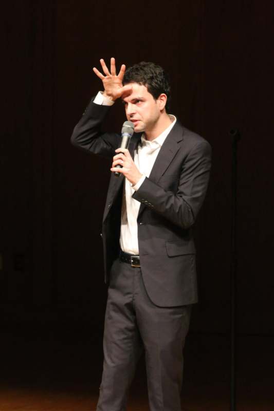a man in a suit holding a microphone
