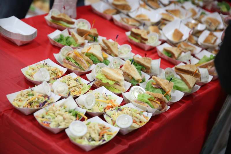a table full of sandwiches and salads