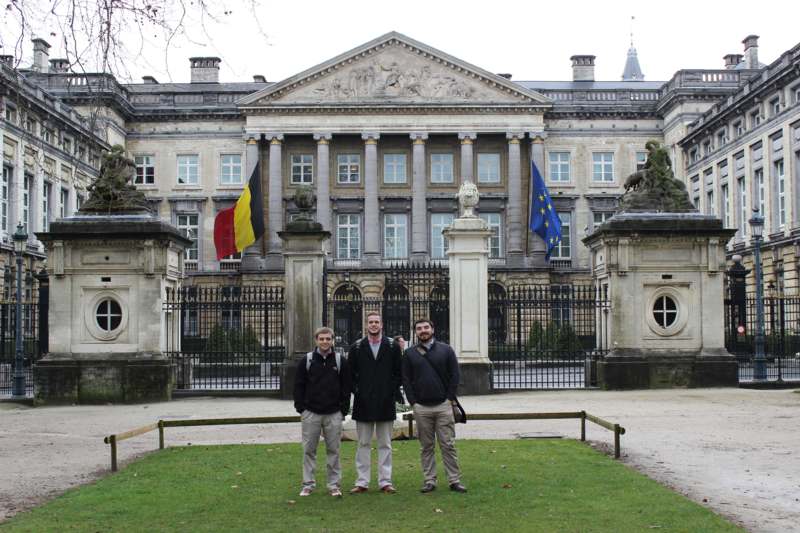 a group of men standing in front of a building