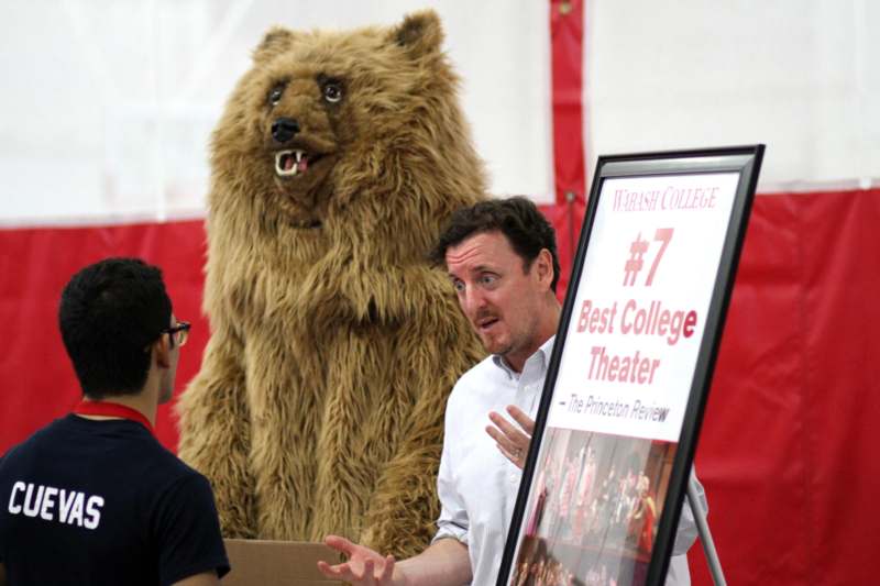 a man talking to a person in a bear garment