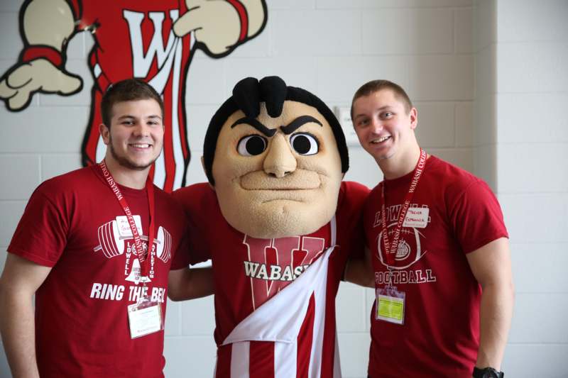 a group of men posing with a mascot