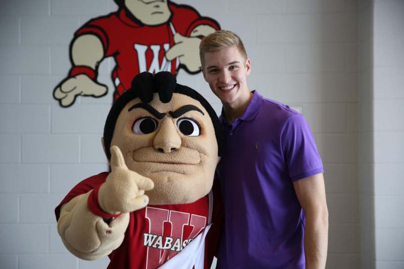 a man standing next to a person in a mascot garment