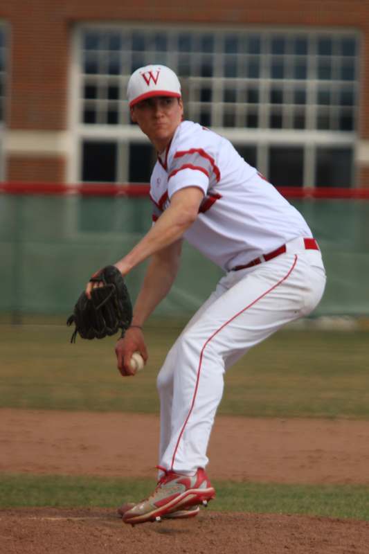 a man in a baseball uniform throwing a ball