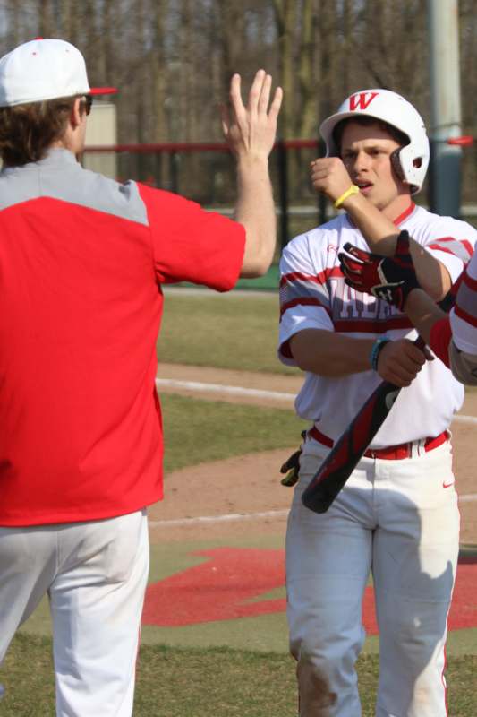 a baseball player giving a high five