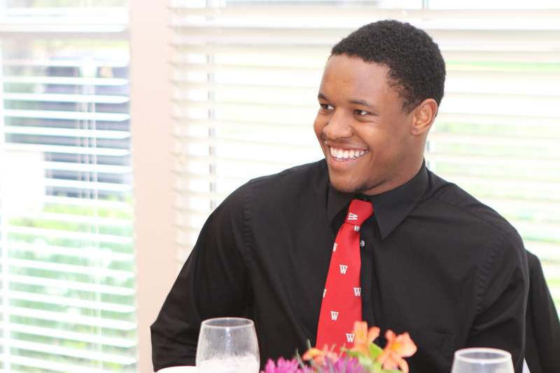 a man smiling at a table