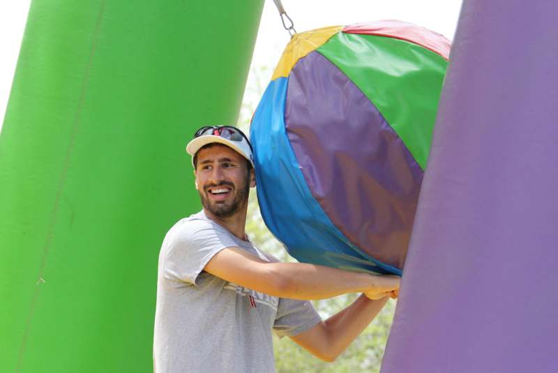 a man holding a large colorful ball