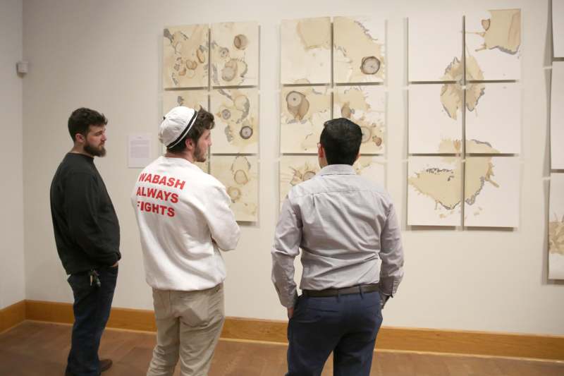 a group of men looking at art