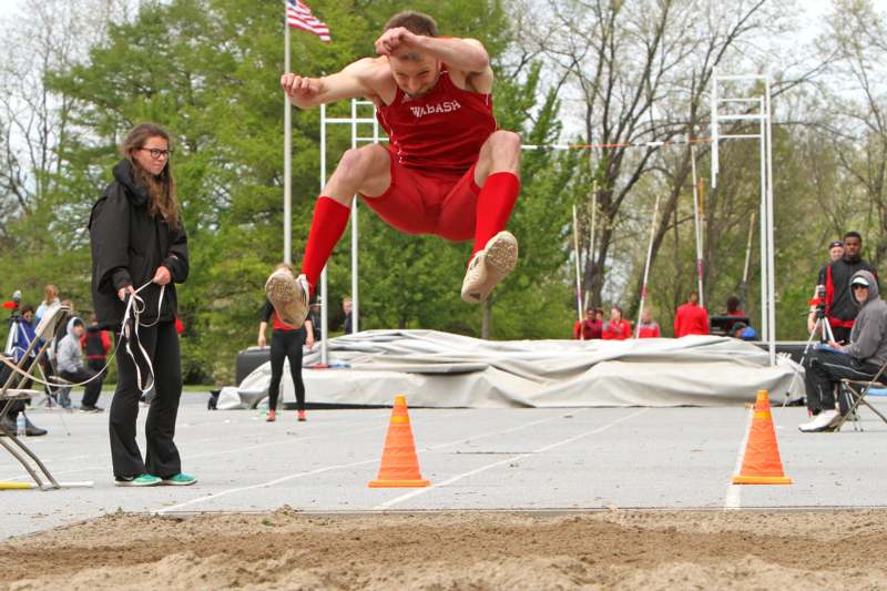 a man jumping over a track