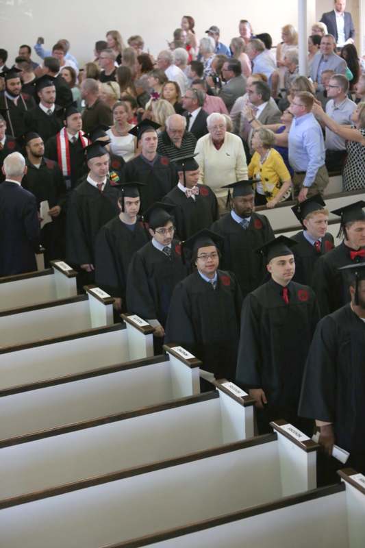 a group of people in graduation gowns and caps