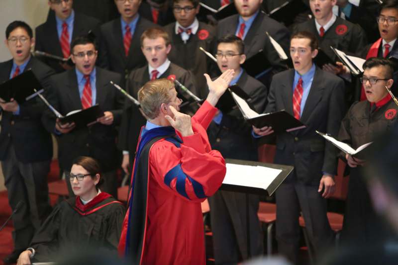 a group of people singing in choir