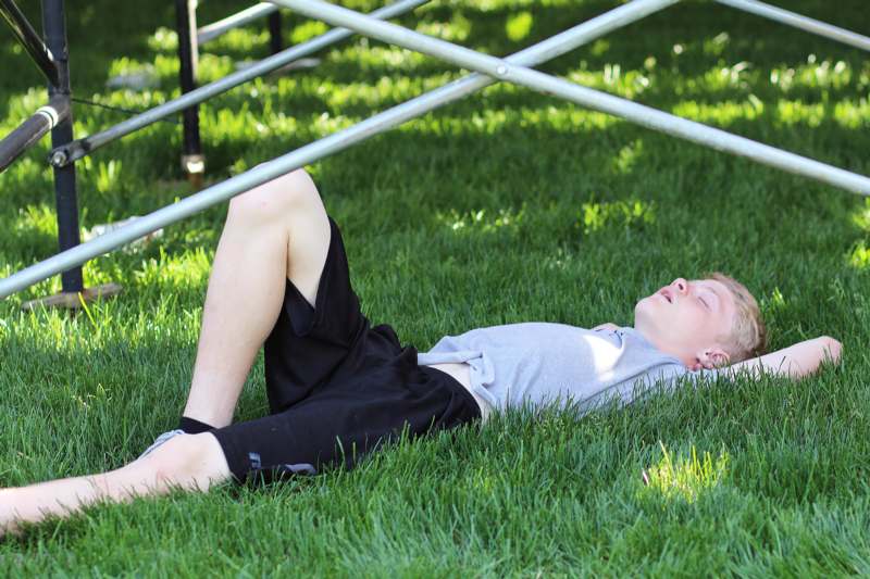 a boy lying on grass