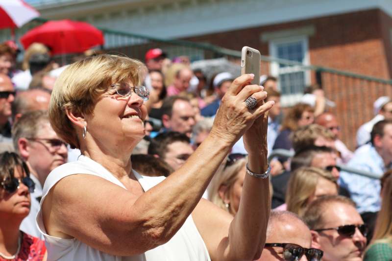a woman taking a selfie with a crowd of people