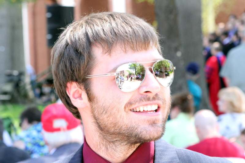 a man wearing sunglasses smiling