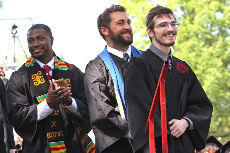 a group of men wearing graduation robes