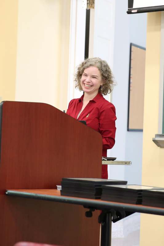 a woman standing behind a podium