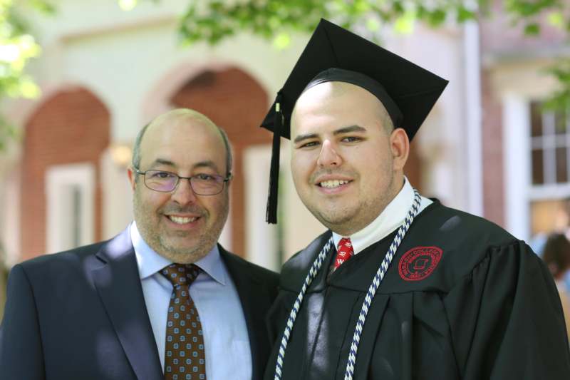 a man in a graduation gown and cap