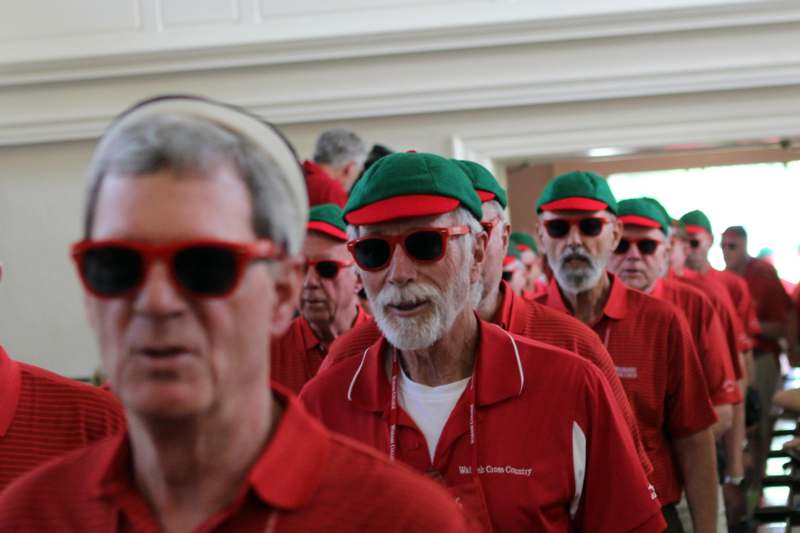 a group of men wearing red and green hats