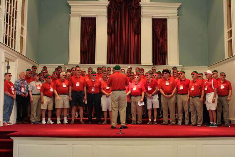 a group of people wearing red shirts and hats