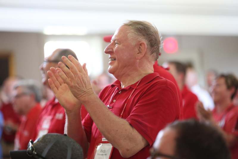 a man in red shirt clapping