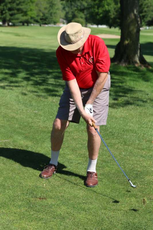 a man in a hat playing golf