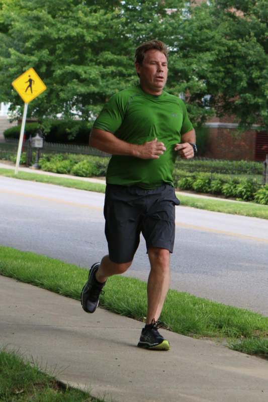 a man running on the sidewalk
