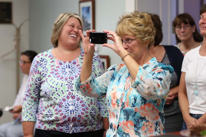 a woman taking a selfie with another woman