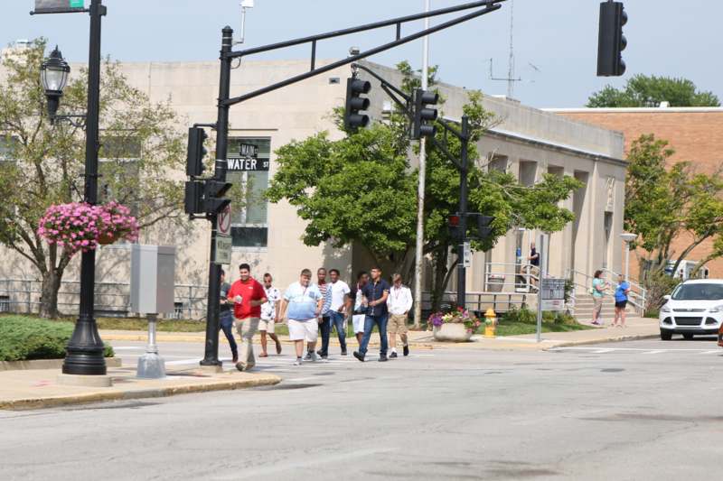 a group of people crossing a street