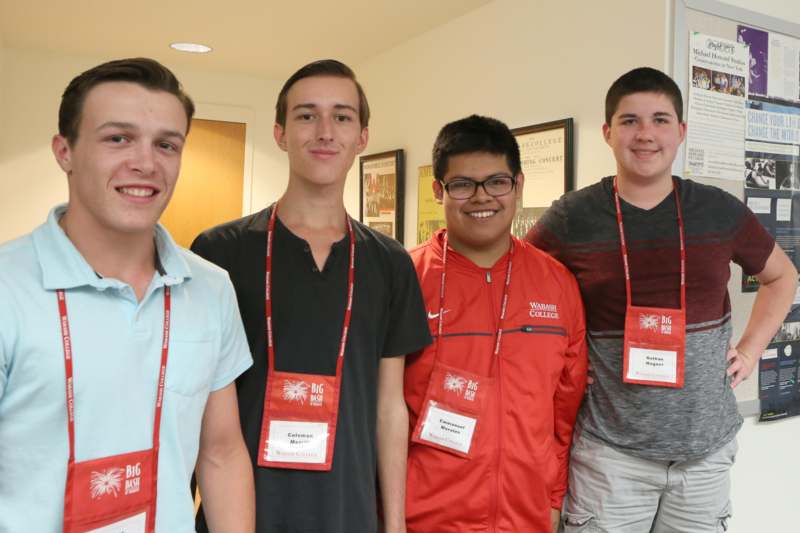 a group of young men wearing lanyards