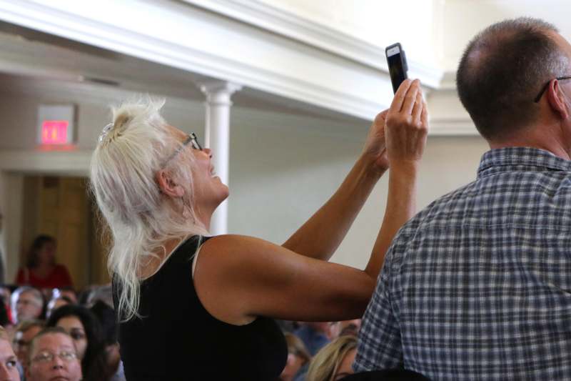 a woman taking a picture of a man