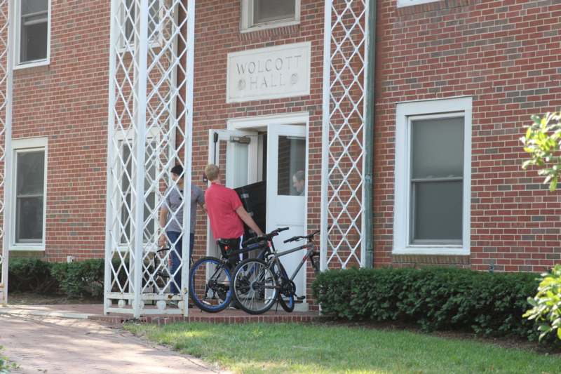 a man with bicycles outside of a building