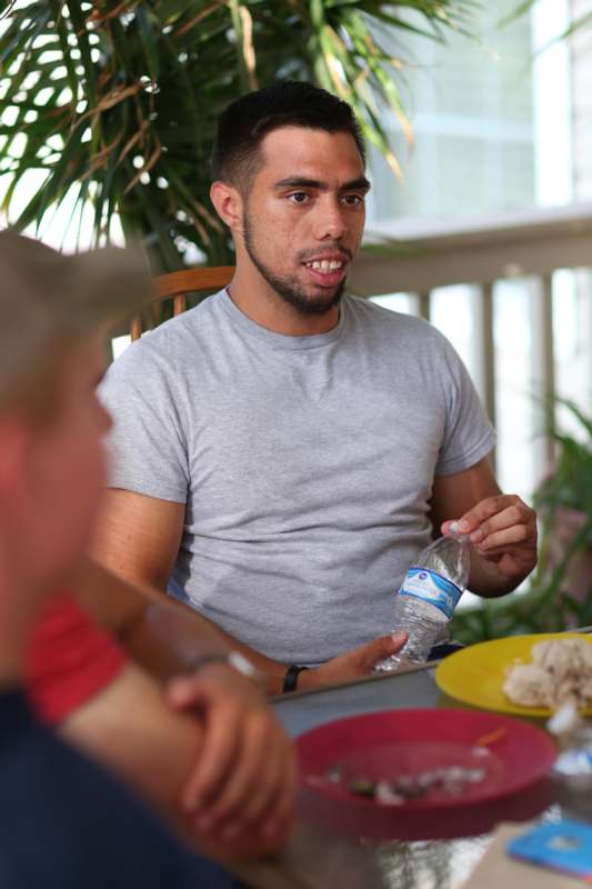 a man sitting at a table with a bottle of water
