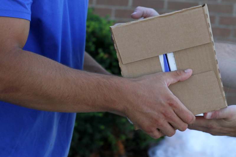 a person holding a cardboard box