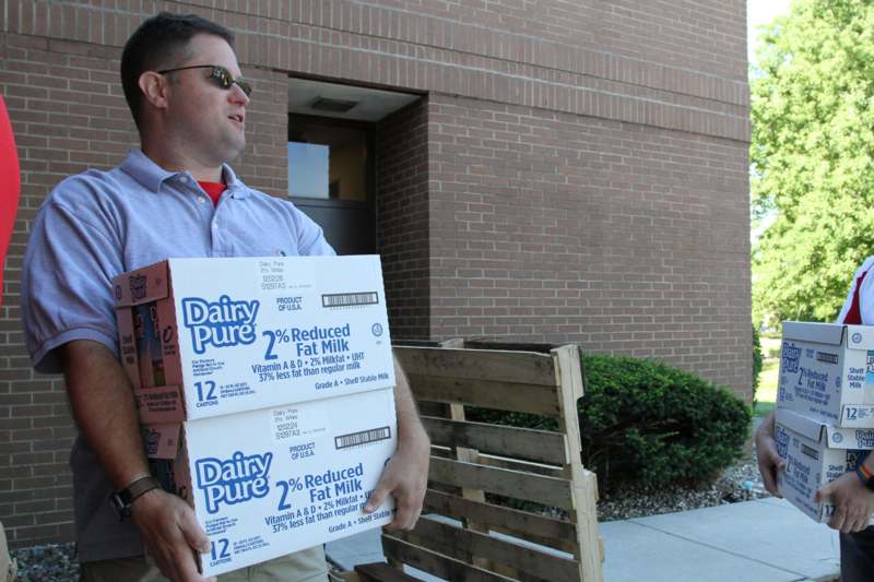 a man carrying boxes outside a building