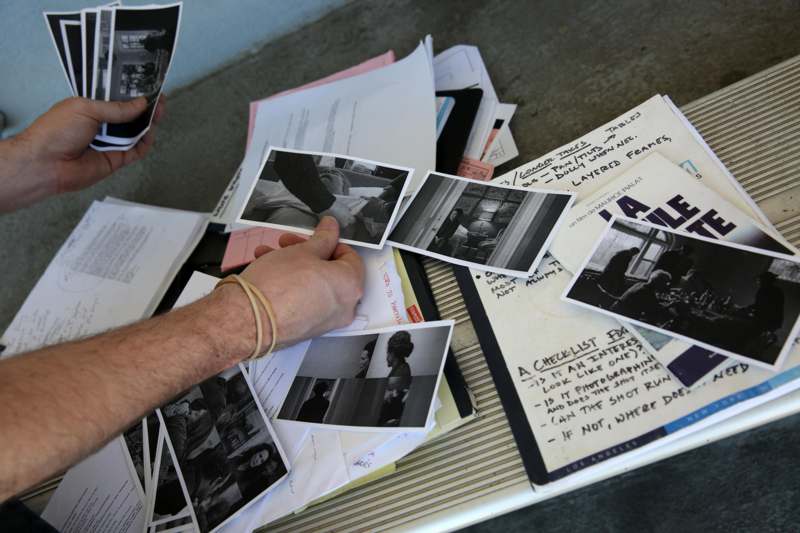 a person holding a pile of photographs