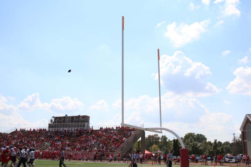 a football goal post with people watching