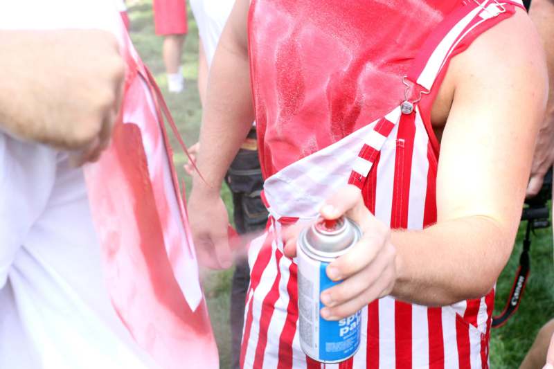 a person spraying a red and white flag