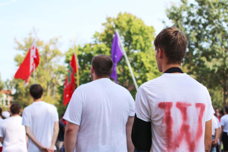 a group of people with red paint on their shirt