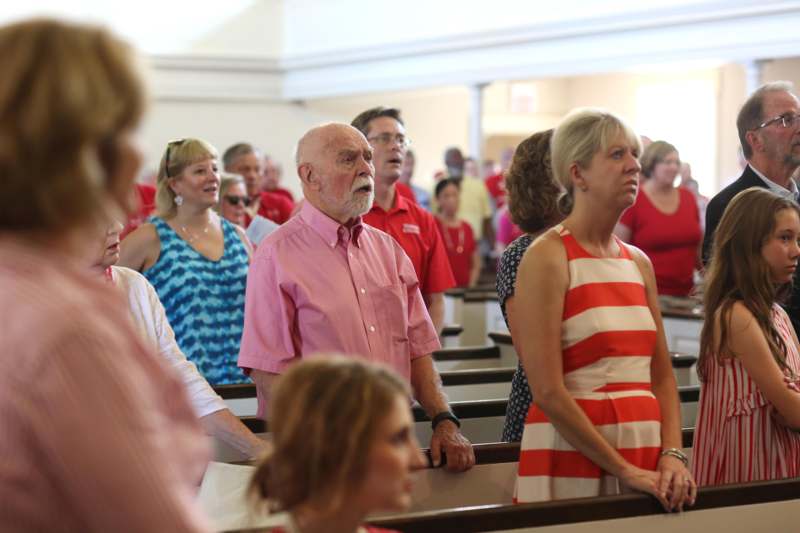 a group of people standing in a church