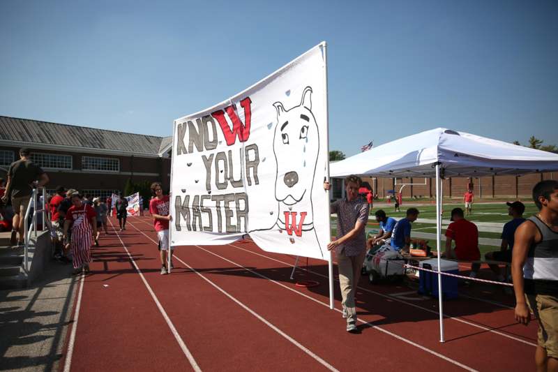 a group of people on a track holding a banner