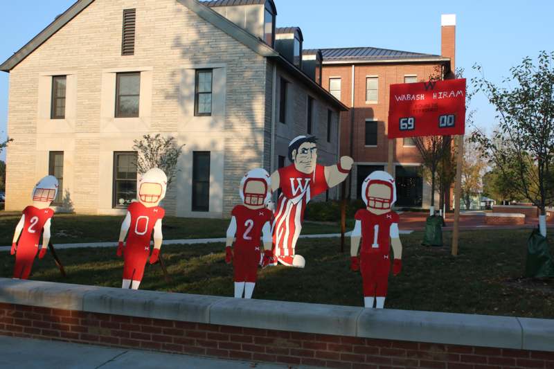 a group of cut out football players in a yard