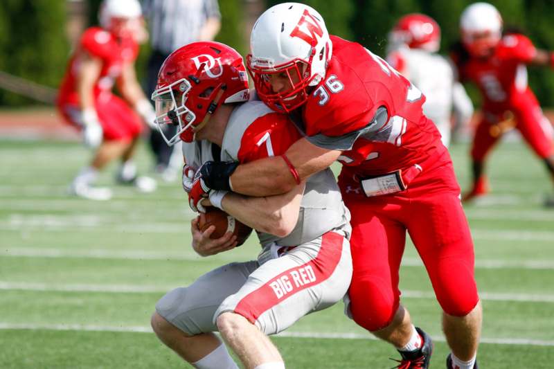 a football players in red and white uniforms on a field