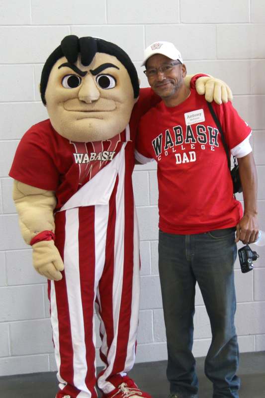 a man standing next to a person in a mascot garment