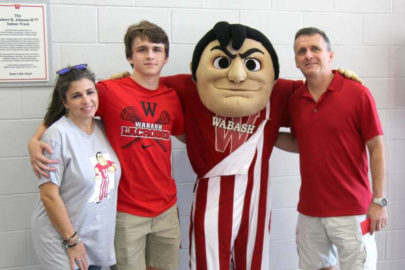 a group of people posing with a mascot
