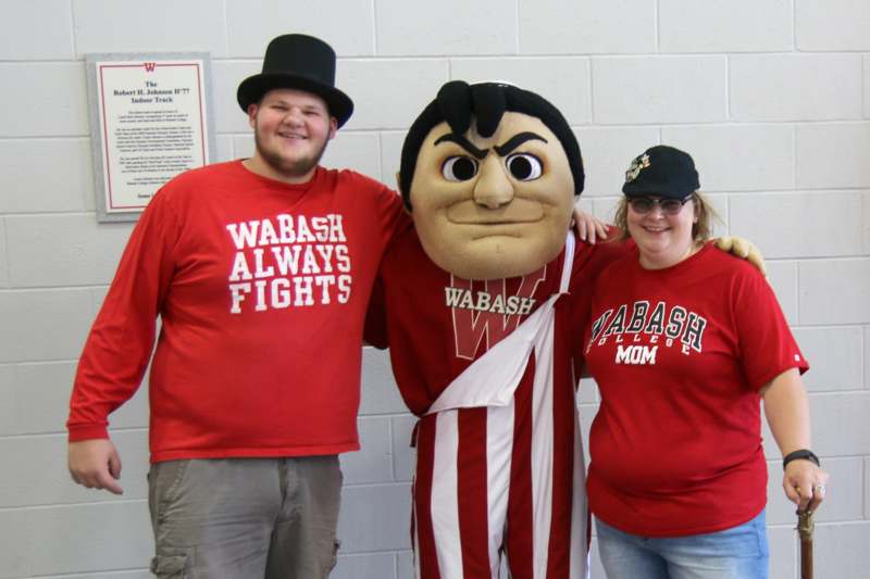 a group of people posing with a mascot