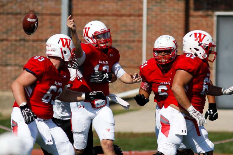 a group of football players in red and white uniforms