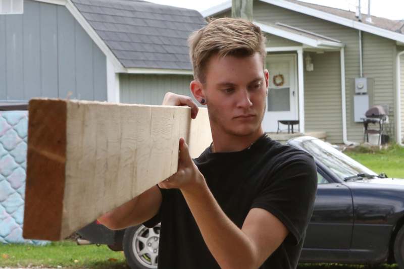 a man holding a piece of wood