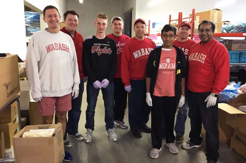 a group of men wearing matching red shirts and gloves